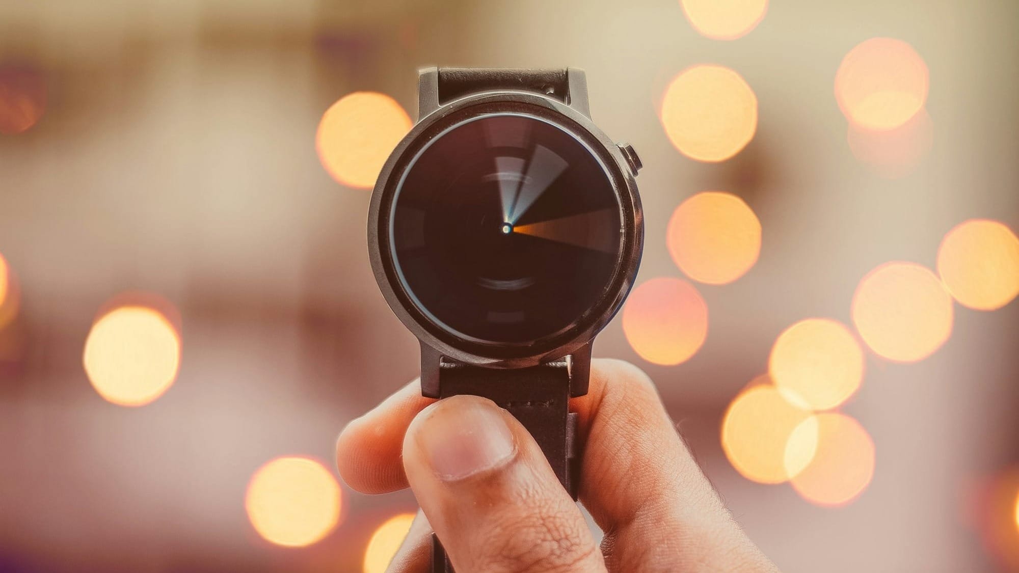 round silver-colored smartwatch bokeh photography